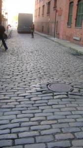 Below Whitman's old window, the street is still cobblestoned.